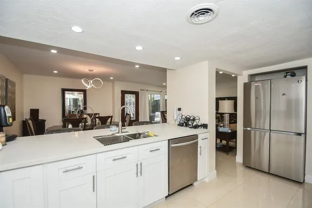 a kitchen with a sink and refrigerator