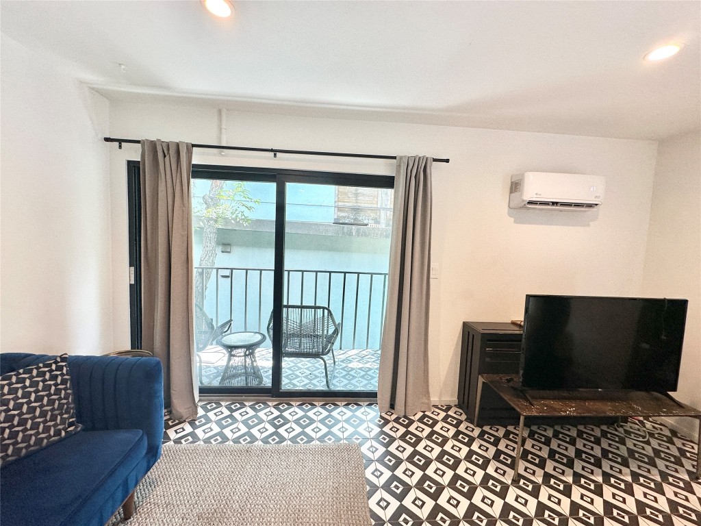 201 Academy Drive, Unit 201 Austin, TX 78704 - Photo 10 of 15 a bedroom with furniture and a window