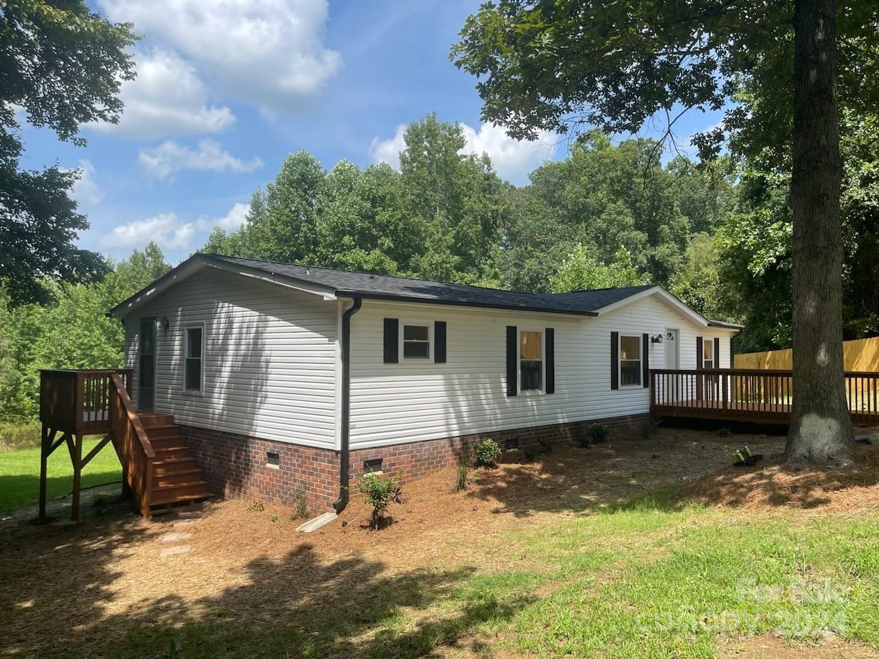 1450 Quarry Road Woodleaf, NC 27054 - Photo 1 of 23 a view of a house with a yard