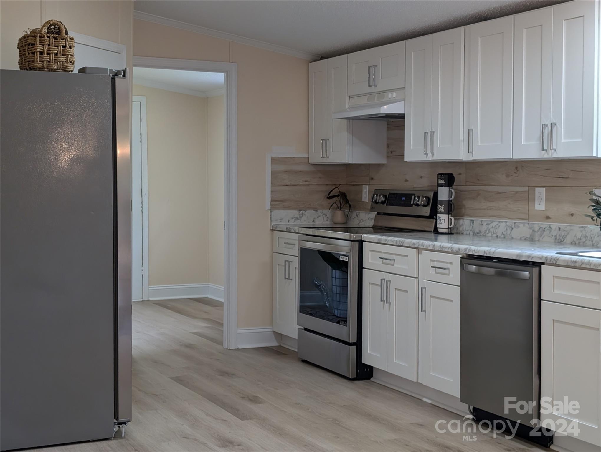 1450 Quarry Road Woodleaf, NC 27054 - Photo 11 of 23 a kitchen with a stove top oven sink and cabinets