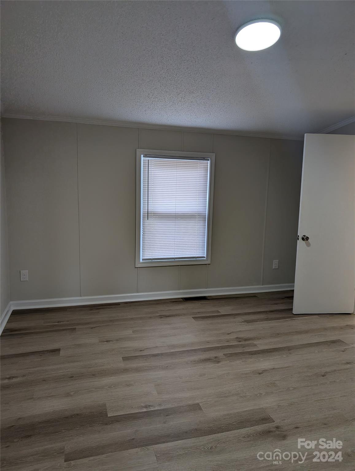1450 Quarry Road Woodleaf, NC 27054 - Photo 14 of 23 a view of an empty room with wooden floor and a window