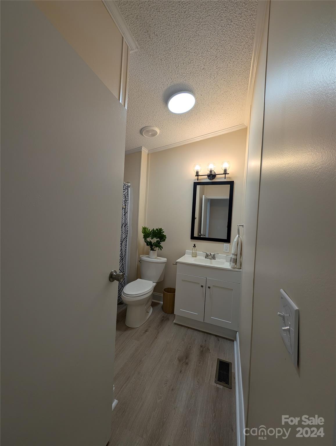 1450 Quarry Road Woodleaf, NC 27054 - Photo 21 of 23 a bathroom with a toilet sink and mirror