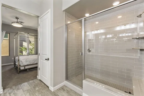 a bathroom with a glass shower door
