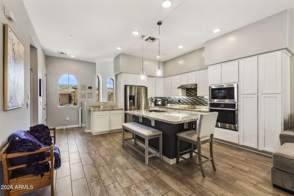 a kitchen with stainless steel appliances kitchen island granite countertop a sink and cabinets