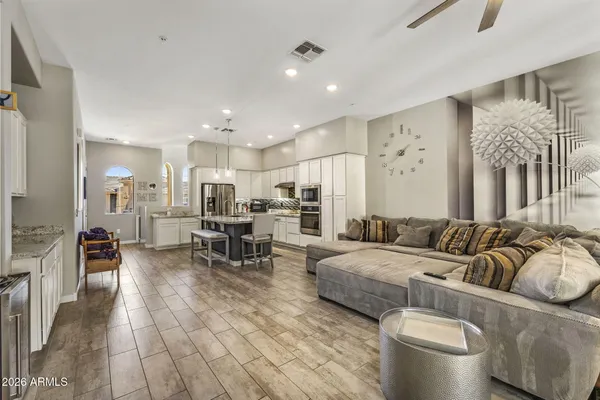 a living room with furniture and a dining table with kitchen view