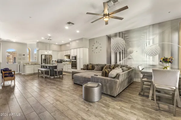 a living room with furniture and kitchen view
