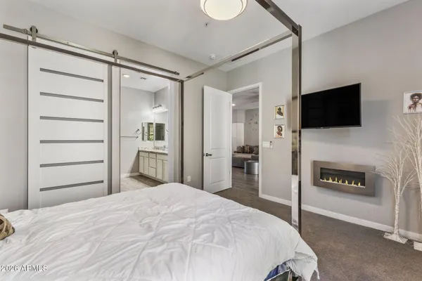 a bedroom with a bed and a flat screen tv