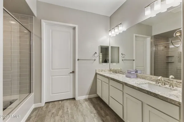 a bathroom with a double vanity sink and mirror