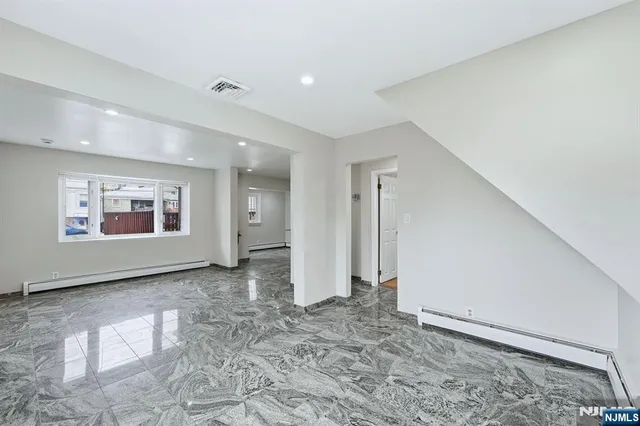 a view of empty room with a fireplace