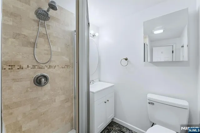 a bathroom with a sink a mirror a shower and vanity