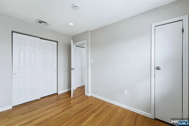 a view of room with wooden floor