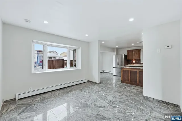 a view of kitchen with stove and refrigerator