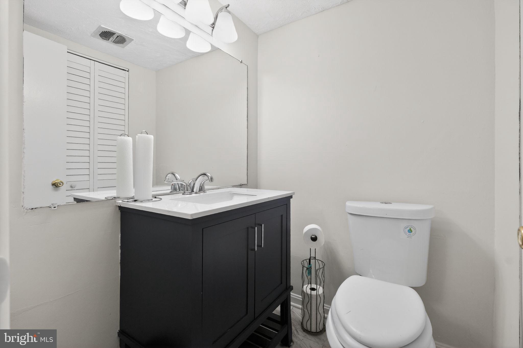 8587 Seasons Way, Unit 6B Lanham, MD 20706 - Photo 11 of 17 a bathroom with a sink vanity mirror and toilet