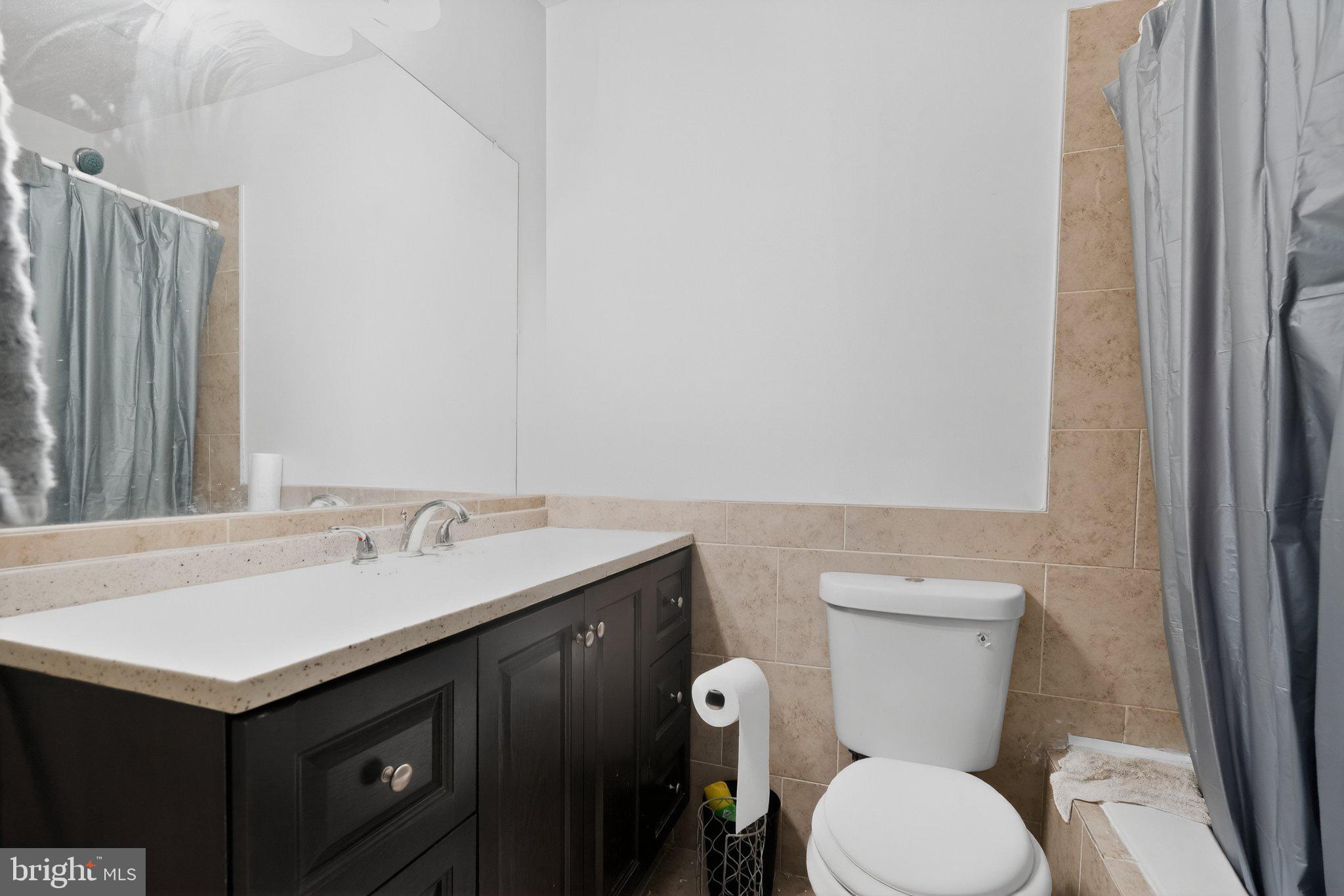 8587 Seasons Way, Unit 6B Lanham, MD 20706 - Photo 16 of 17 a bathroom with a sink toilet and vanity