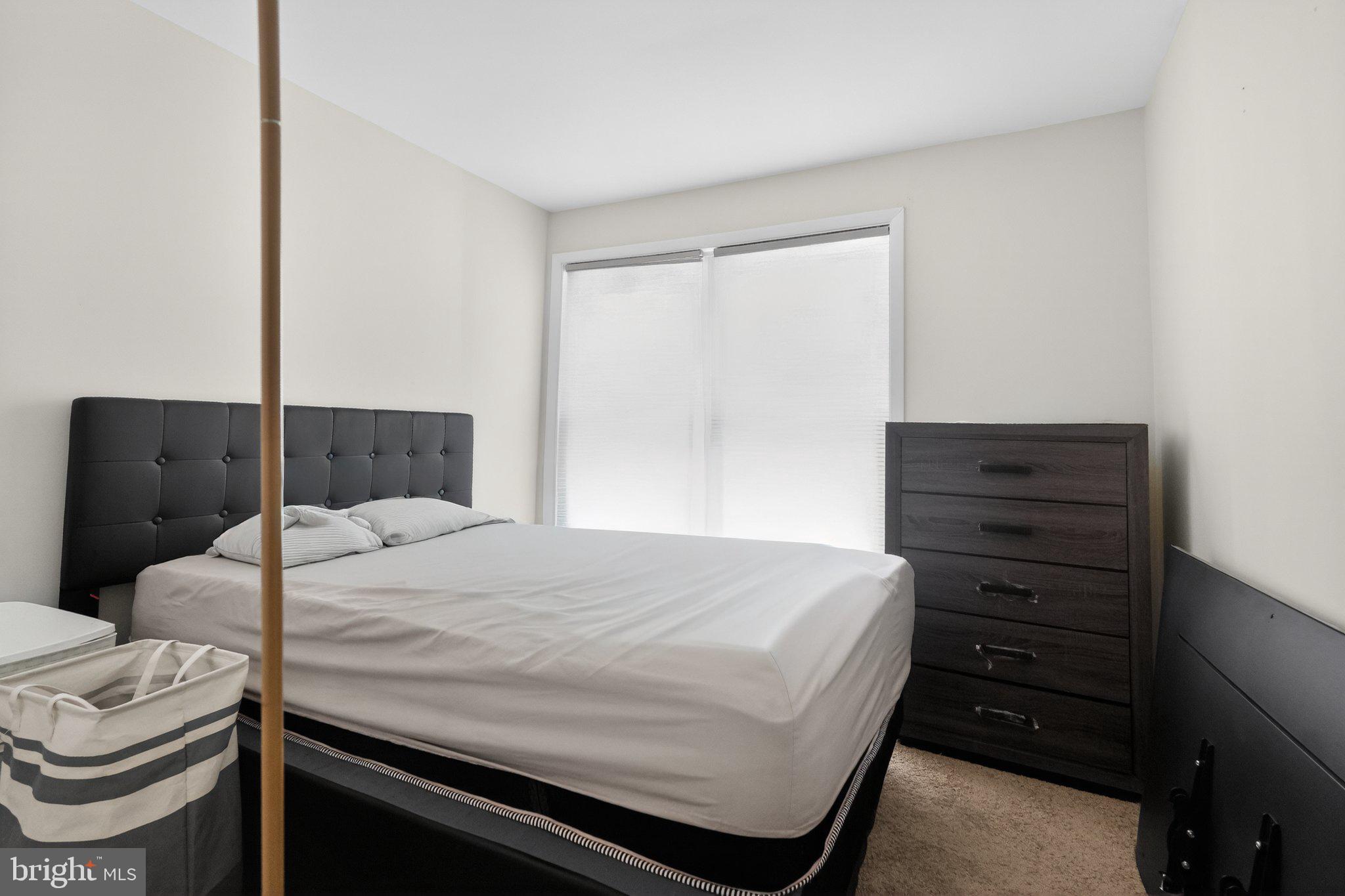 8587 Seasons Way, Unit 6B Lanham, MD 20706 - Photo 17 of 17 a bedroom with a bed and a dresser
