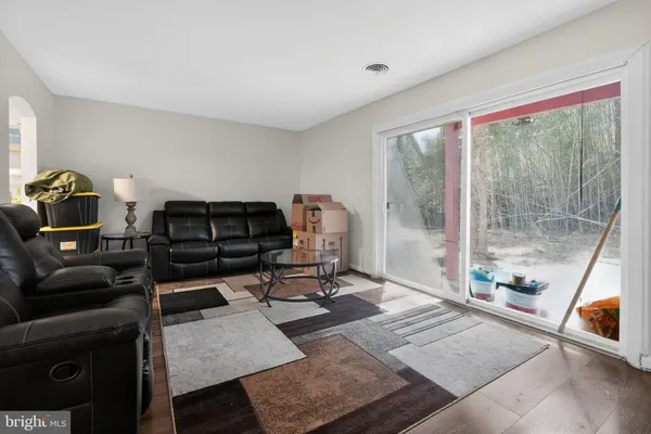 a living room with furniture and a floor to ceiling window