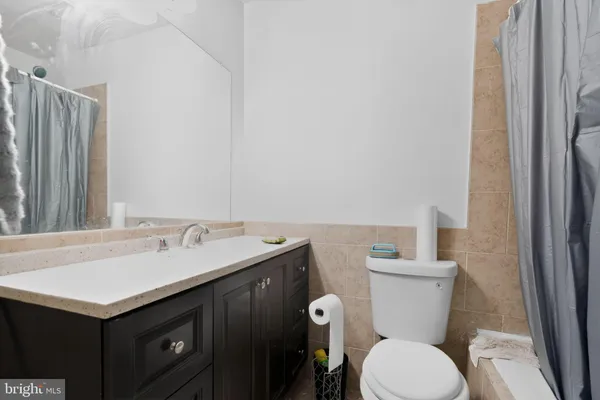 a bathroom with a sink mirror vanity and toilet