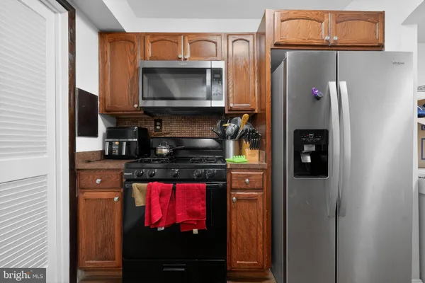 a kitchen with a refrigerator stove and microwave
