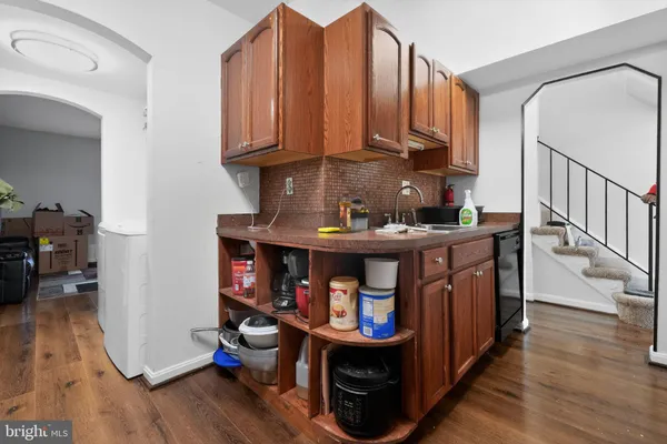 a view of dining room with wooden floor and stairs