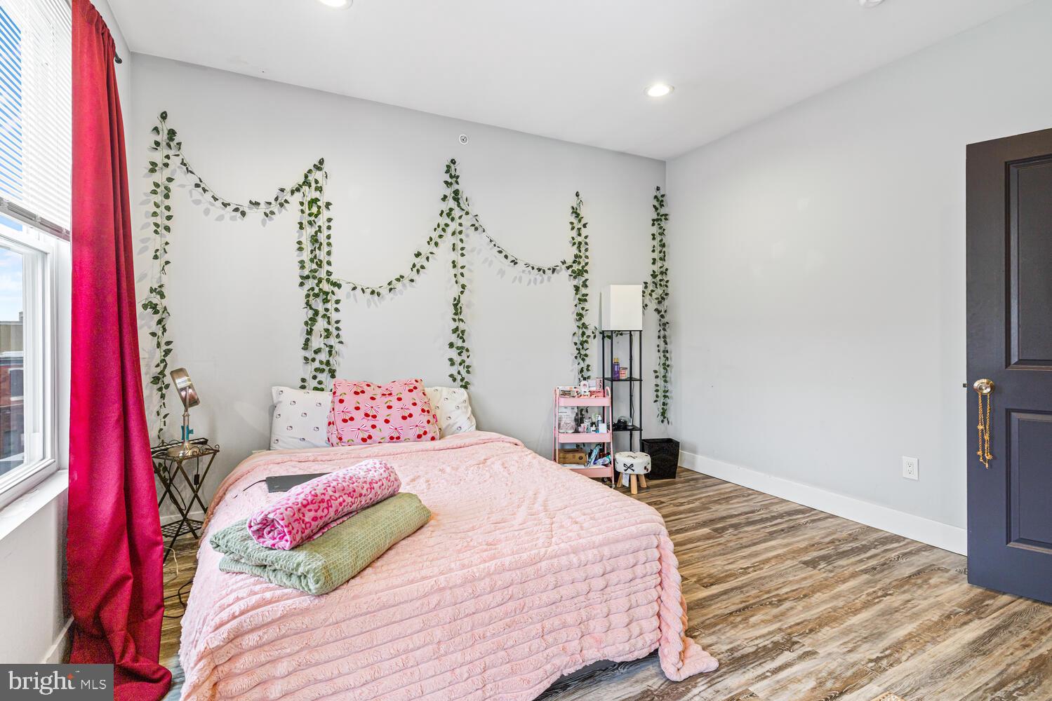 1214 South 20th Street Philadelphia, PA 19146 - Photo 12 of 34 a bedroom with a bed and a chandelier