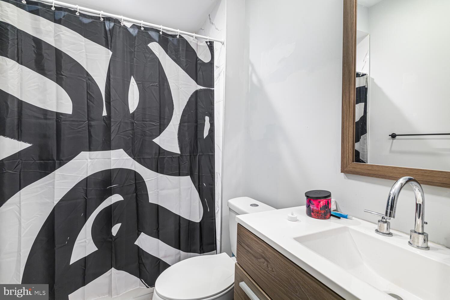 1214 South 20th Street Philadelphia, PA 19146 - Photo 27 of 34 a bathroom with a sink vanity mirror and toilet