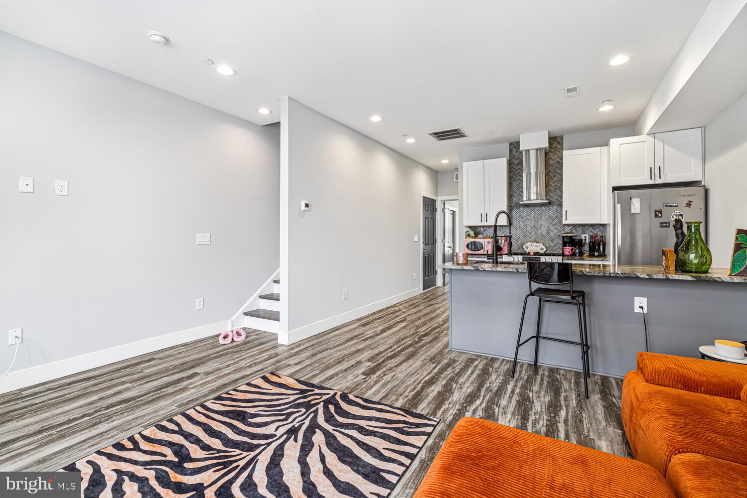 1214 South 20th Street Philadelphia, PA 19146 - Photo 5 of 34 a living room with stainless steel appliances furniture a rug and a kitchen view