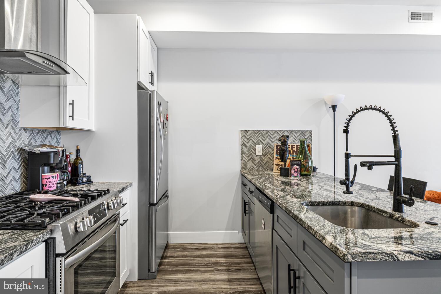 1214 South 20th Street Philadelphia, PA 19146 - Photo 7 of 34 a kitchen with stainless steel appliances granite countertop a sink stove and refrigerator