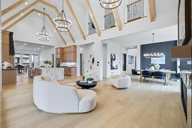 a living room with furniture and a chandelier