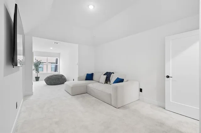 a living room with furniture a window and wooden floor