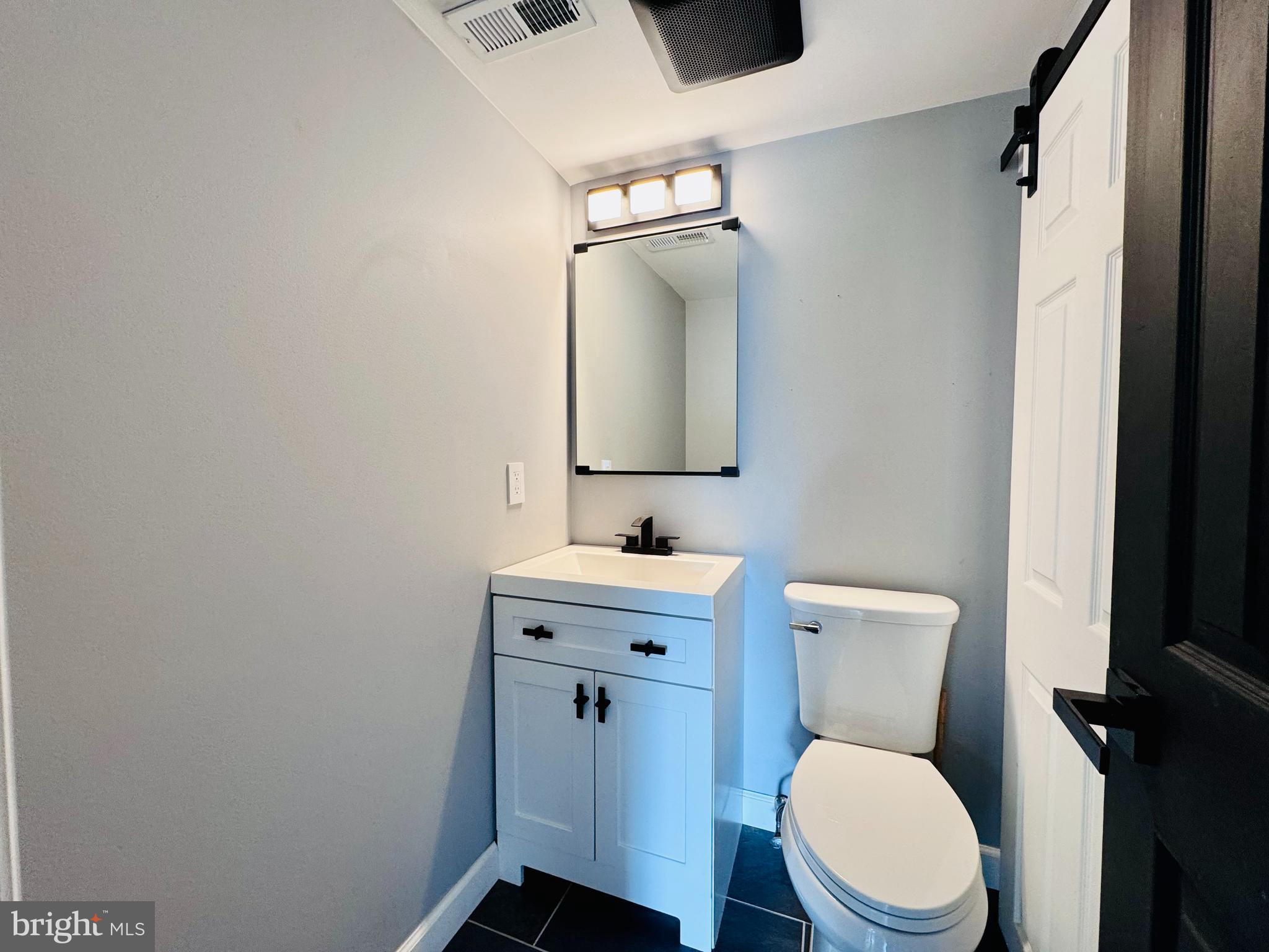 1403 Roberts Way Voorhees, NJ 08043 - Photo 11 of 22 a bathroom with a toilet a sink and mirror