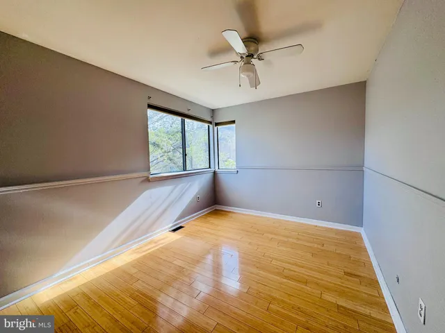 a view of a room with a window and ceiling fan