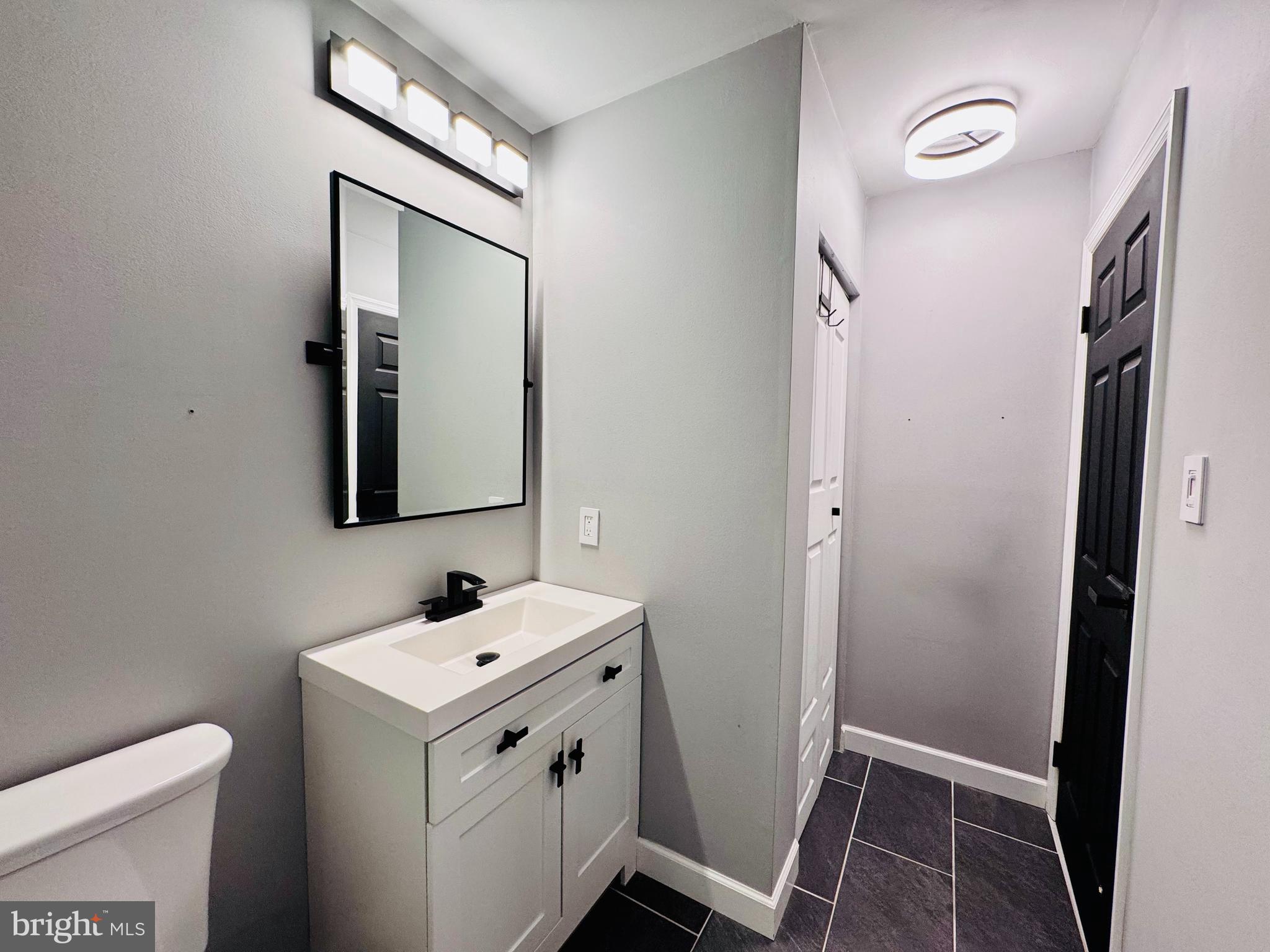 1403 Roberts Way Voorhees, NJ 08043 - Photo 19 of 22 a bathroom with a sink and a mirror