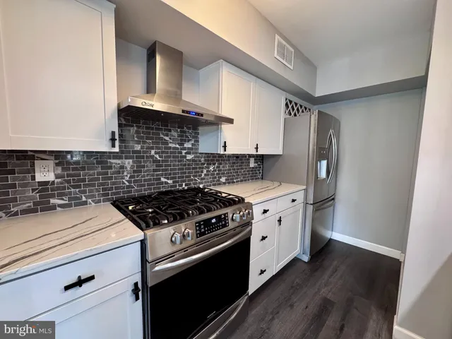 a kitchen with a stove and a refrigerator