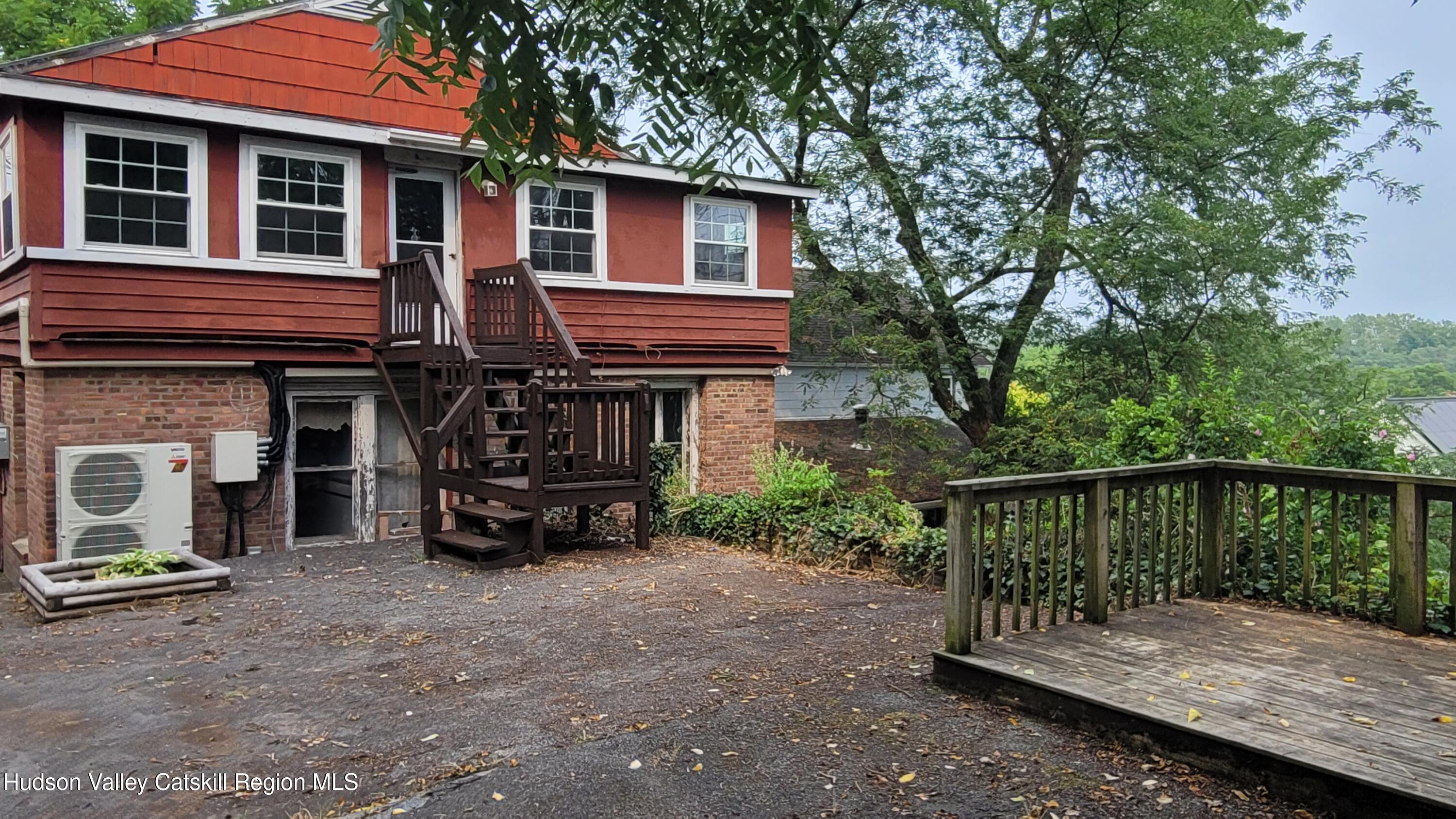 a view of house and car parked in front of house