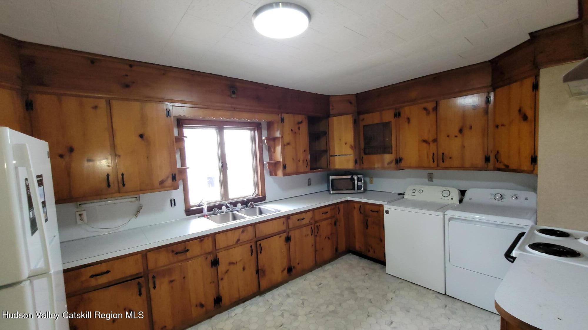 6074 Rte 9W Catskill, NY 12414 - Photo 13 of 15 a large kitchen with a sink and dishwasher a refrigerator with wooden cabinets