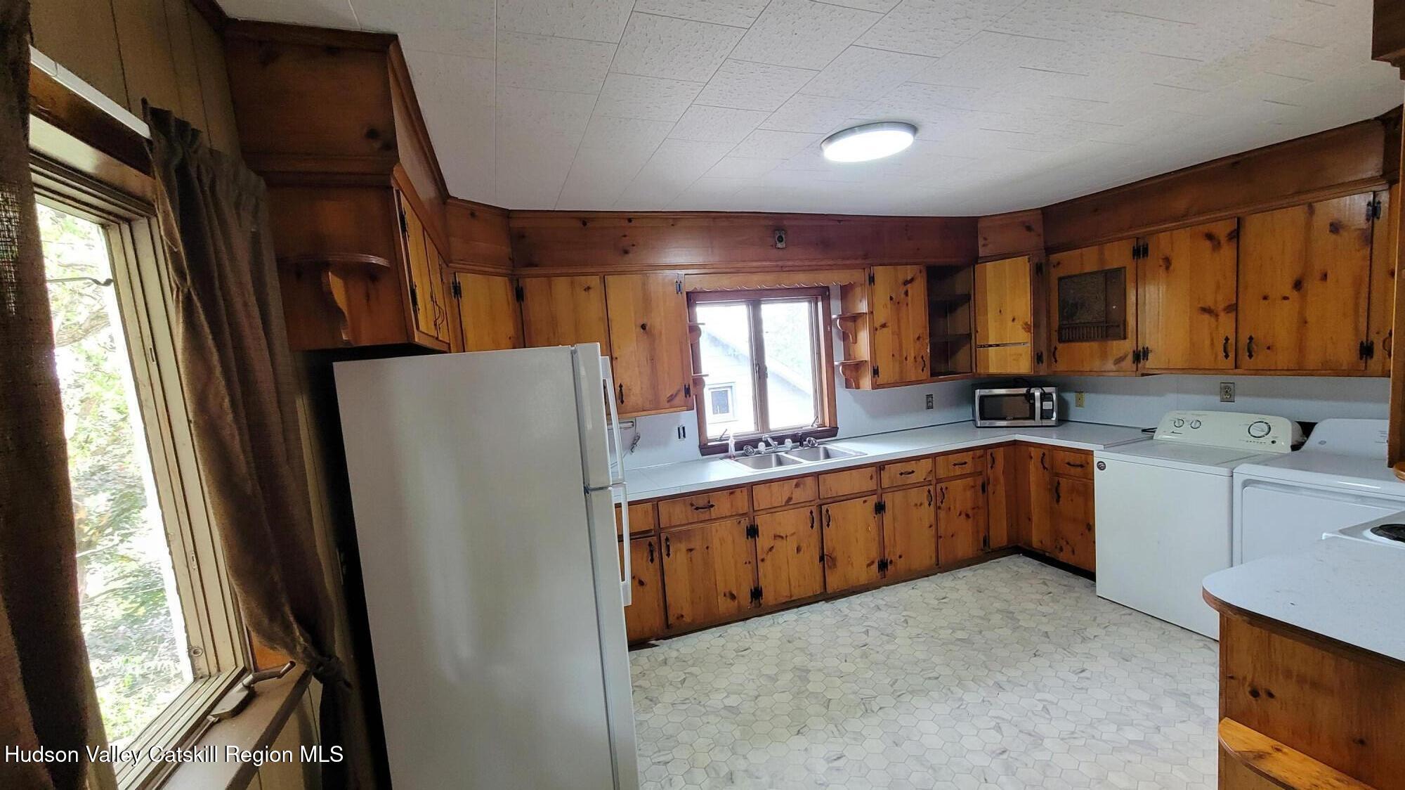 6074 Rte 9W Catskill, NY 12414 - Photo 14 of 15 a kitchen with stainless steel appliances granite countertop a refrigerator a sink dishwasher a stove a microwave oven with cabinets and wooden floor
