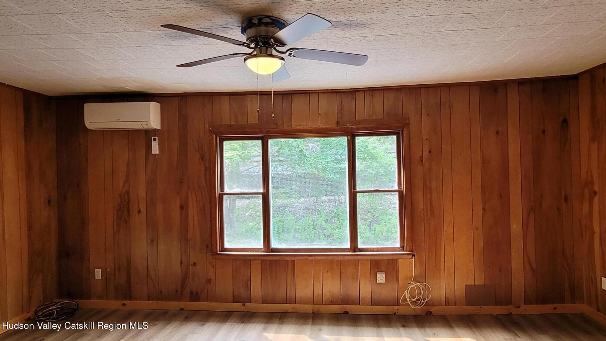 6074 Rte 9W Catskill, NY 12414 - Photo 9 of 15 an empty room with wooden floor and windows