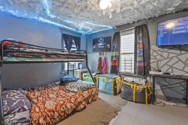 a bedroom with furniture and a flat screen tv