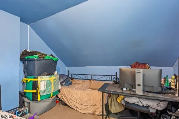 a room with a bed and a television