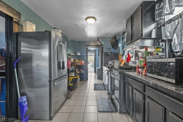 a kitchen with stainless steel appliances granite countertop a refrigerator and a stove