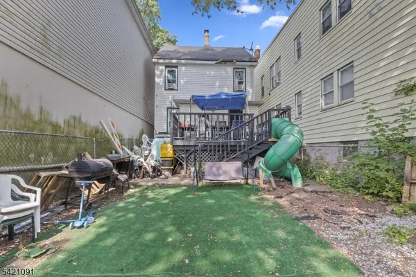 a view of a chairs and table in backyard