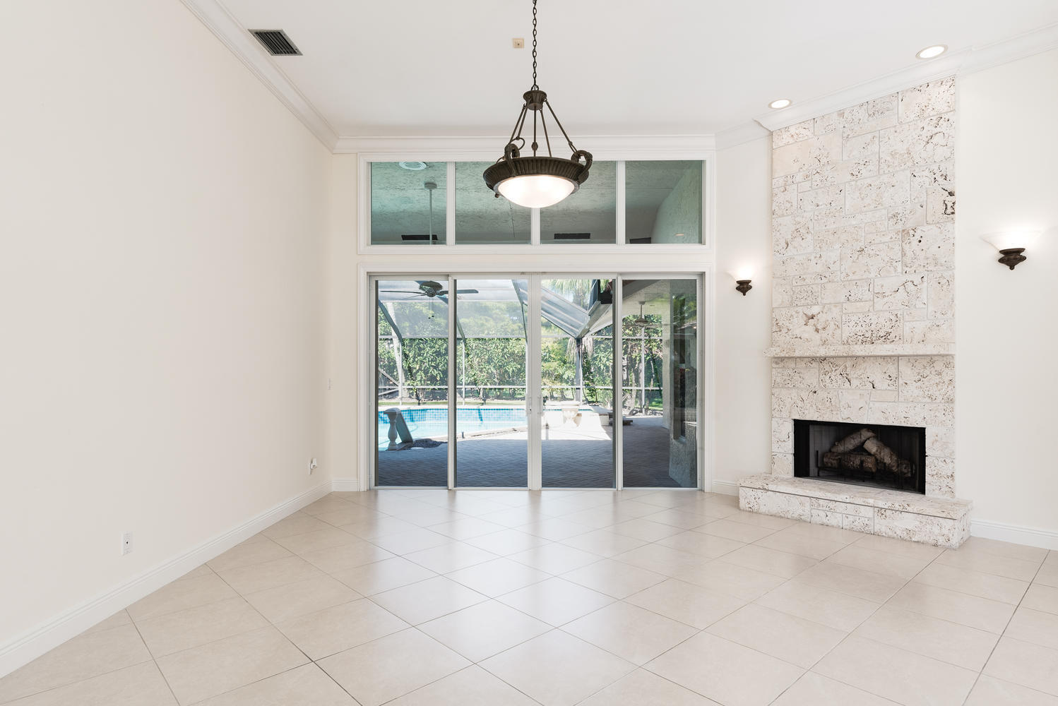 2245 Parkside Street Boca Raton, FL 33486 - Photo 5 of 34 a view of an empty room with a fireplace and a window