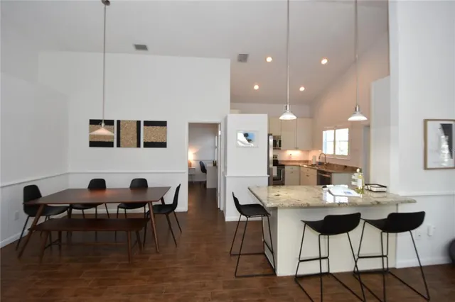 a view of a dining room with furniture and wooden floor