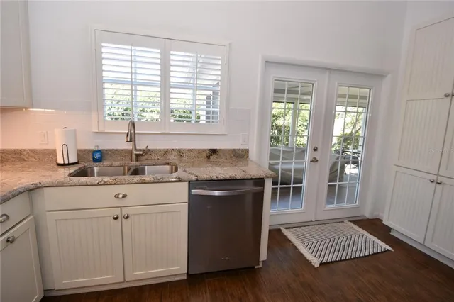 a kitchen with refrigerator a sink a stove a microwave and cabinets
