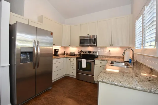 a bathroom with a sink a mirror and a window