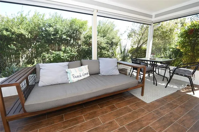 a view of a workspace with furniture and wooden floor