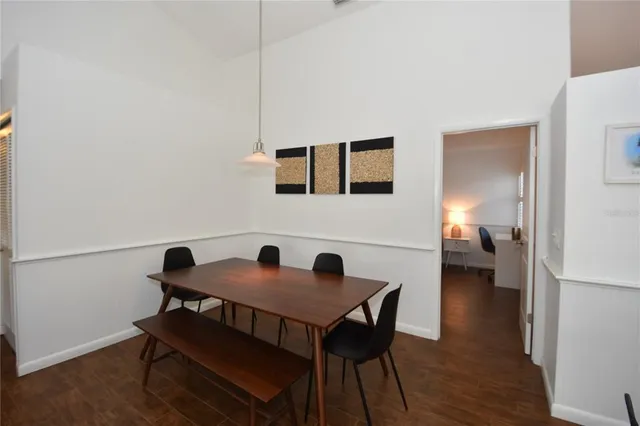 a hallway with a view of bedroom with a large window