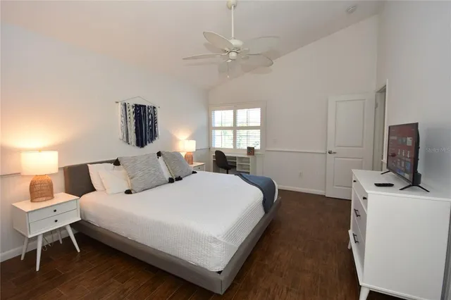 a bedroom with bed and a chandelier