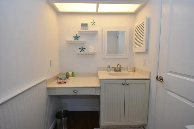 a room with a bench and cabinets