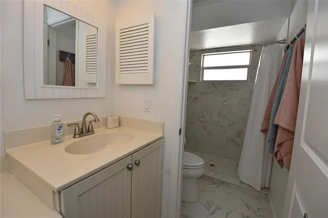 a bathroom with a shower and a toilet
